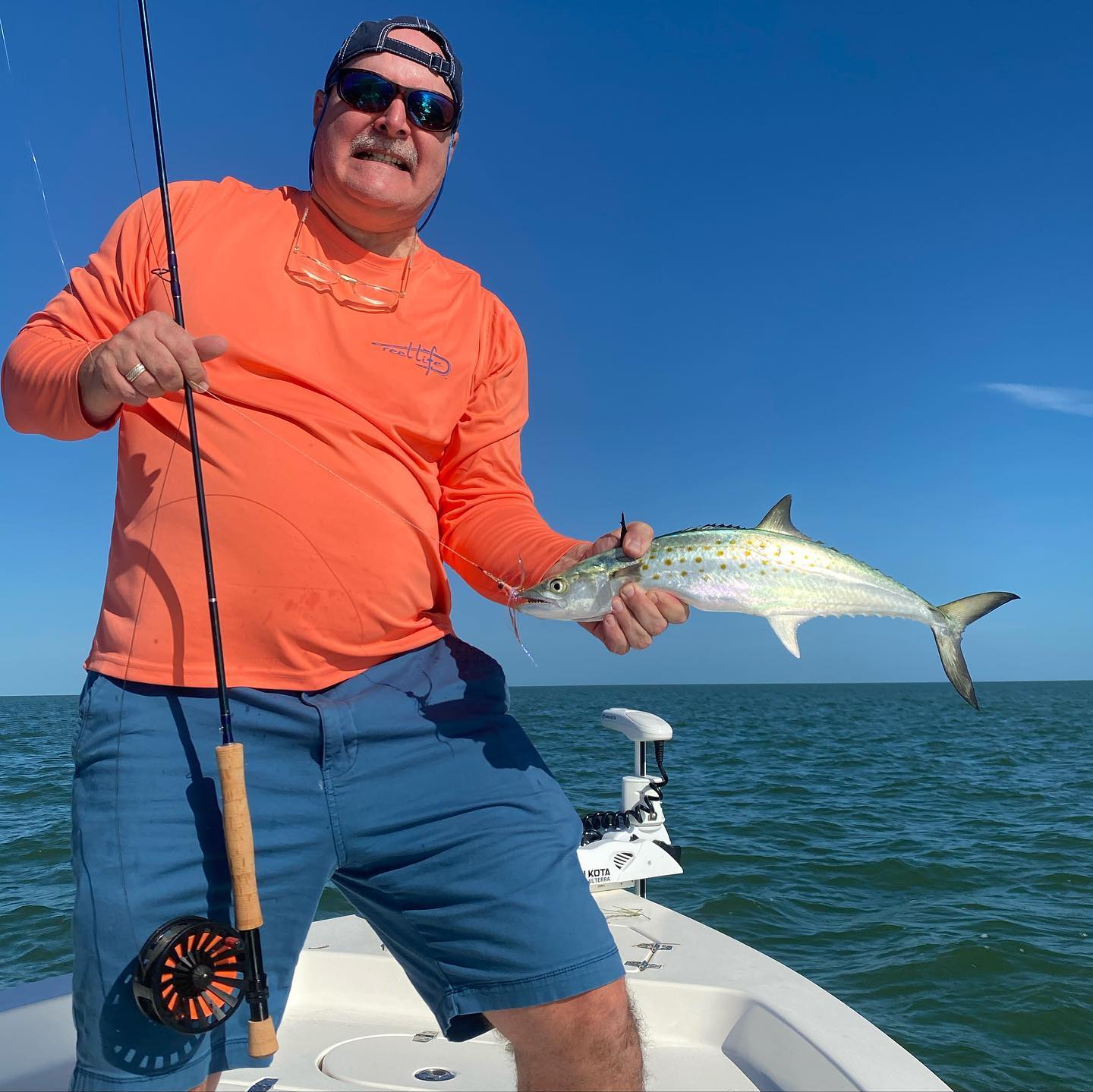 Man holding his fishing pole and fish