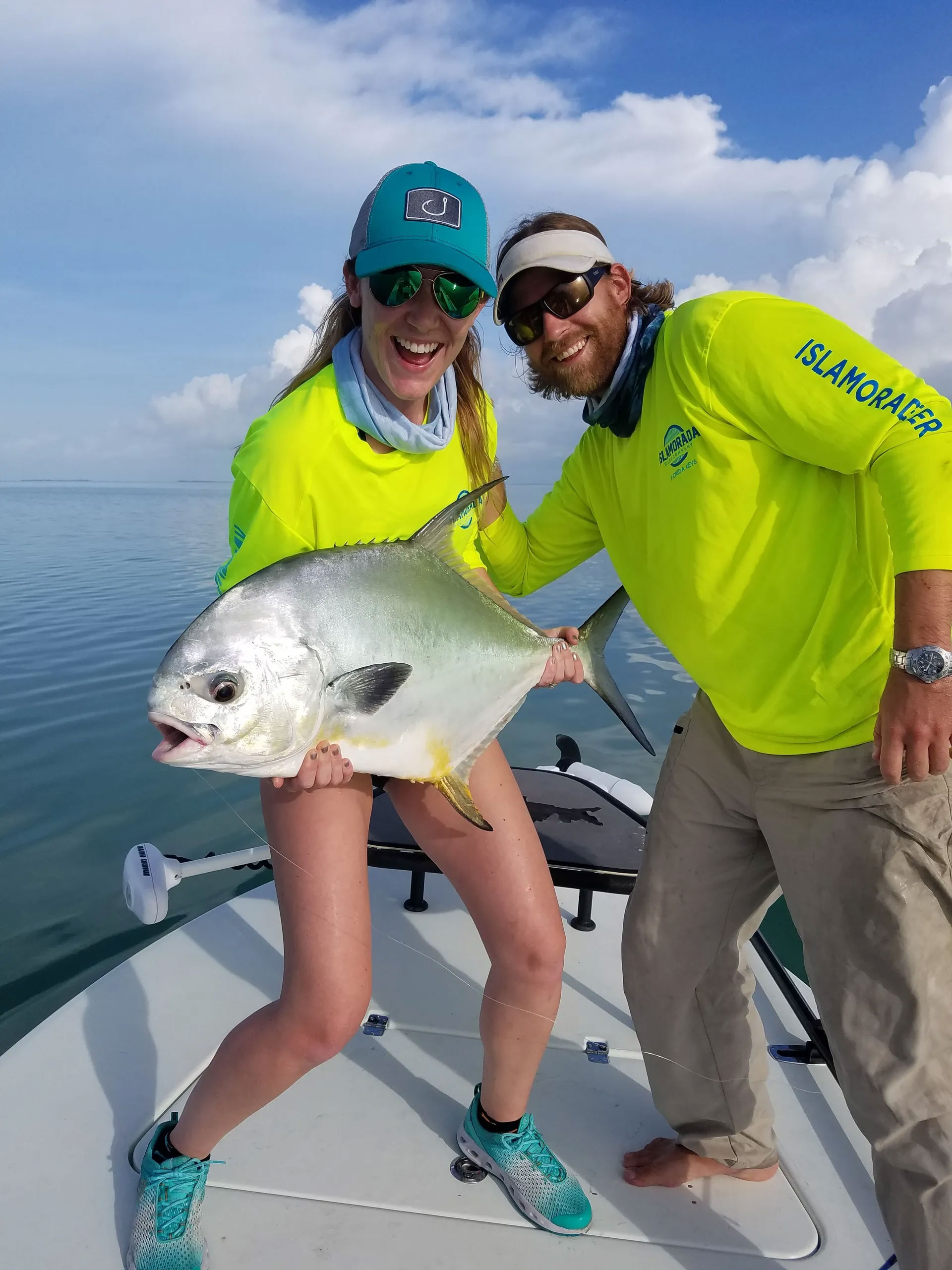 Smiling couple holding a large fish