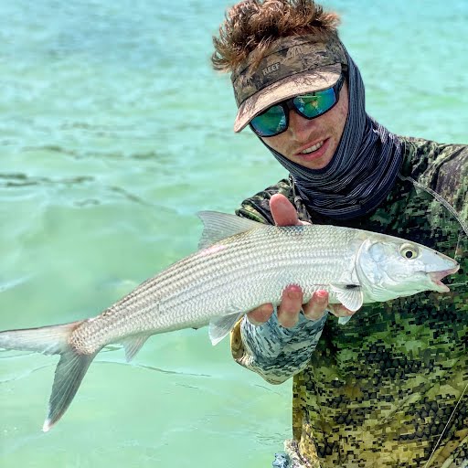 Smiling man in sunglasses holding very large fish.